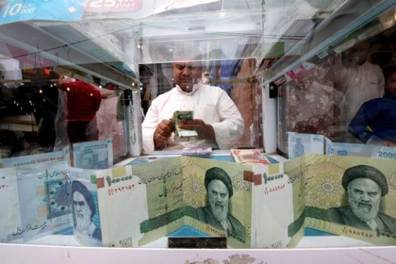 A man counts Iranian rials at a currency exchange shop in Basra, Iraq