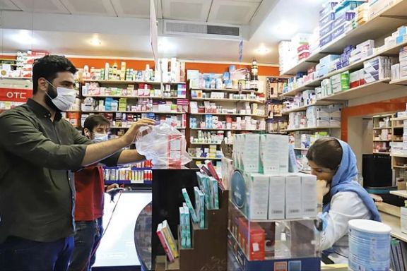 A man takes his medicine at the till of a pharmacy in Tehran