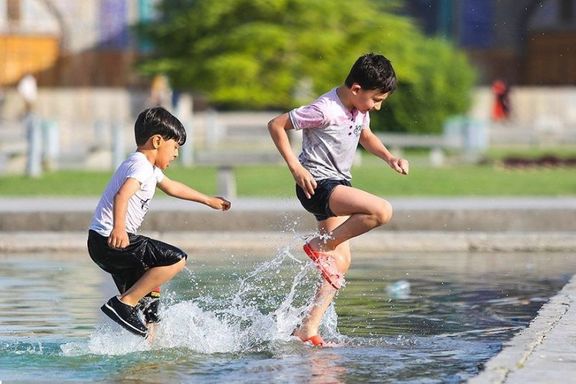 Kids stomping on shallow water to cool down in summer's heat, Isfahan, Iran, August 1, 2020