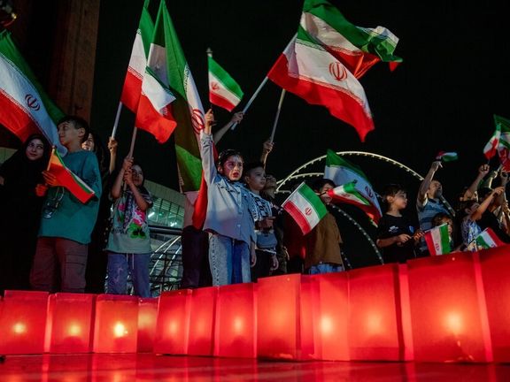 Kids holding Iranian flags in an event to commemorate those killed in Israeli airstrikes, Tehran, Iran, July 31, 2025