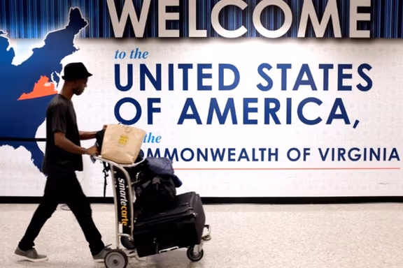 A man exits the transit area after clearing immigration and customs on arrival at Dulles International Airport in Dulles, Virginia, US, September 24, 2017.