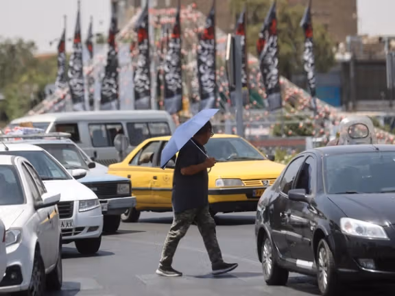 An man walks in a street during the heat surge in Tehran, Iran.