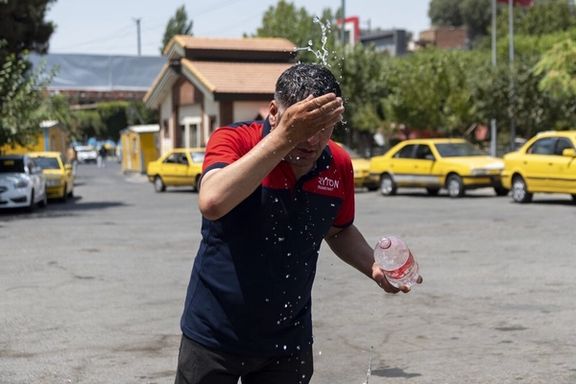 A man splashes water on his face to cool down during the heat surge in Karaj, Iran, July 21, 2025