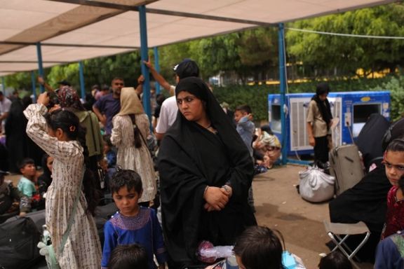 Afghan families deported from Iran waiting at the border to enter Afghanistan, July 6, 2025