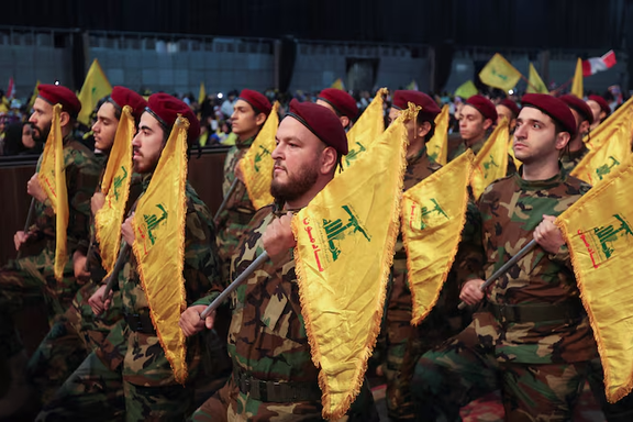 Members of Lebanon's Hezbollah hold flags during a rally commemorating the annual Hezbollah Martyrs' Day in Beirut's southern suburbs, Lebanon November 11, 2022. 