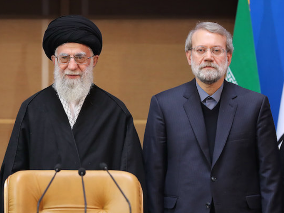 Senior adviser Ali Larijani standing next to supreme leader Ali Khamenei
